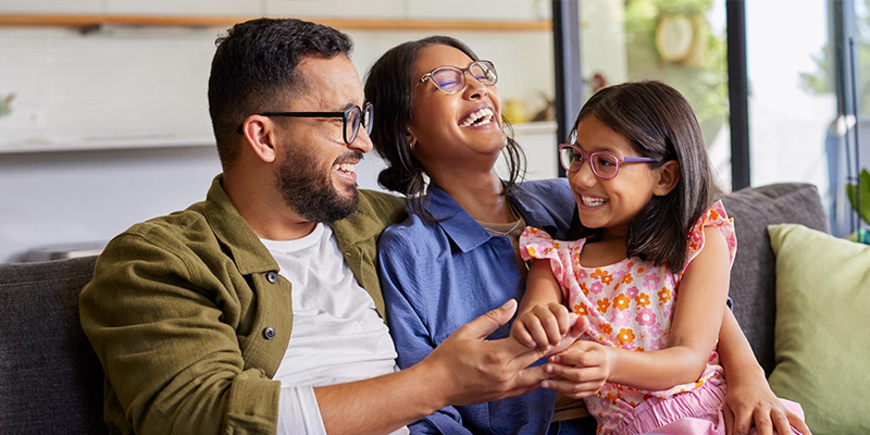 happy family laughing on couch
